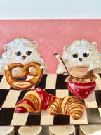 Bakery Buddies dog and pastry acrylic painting displayed in a styled interior setting