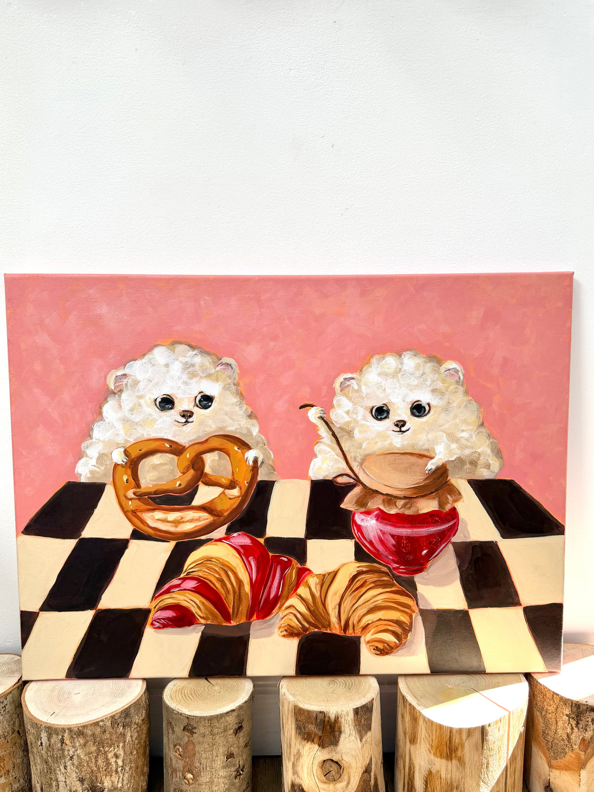 Bakery Buddies whimsical dog and pastry artwork displayed on a clean light wall