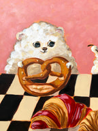 Bakery Buddies dog and pastry acrylic painting displayed in a styled interior setting
