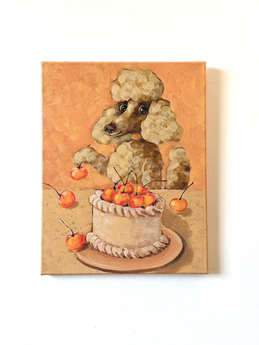 Celebration dog and cake acrylic painting displayed on a clean light wall