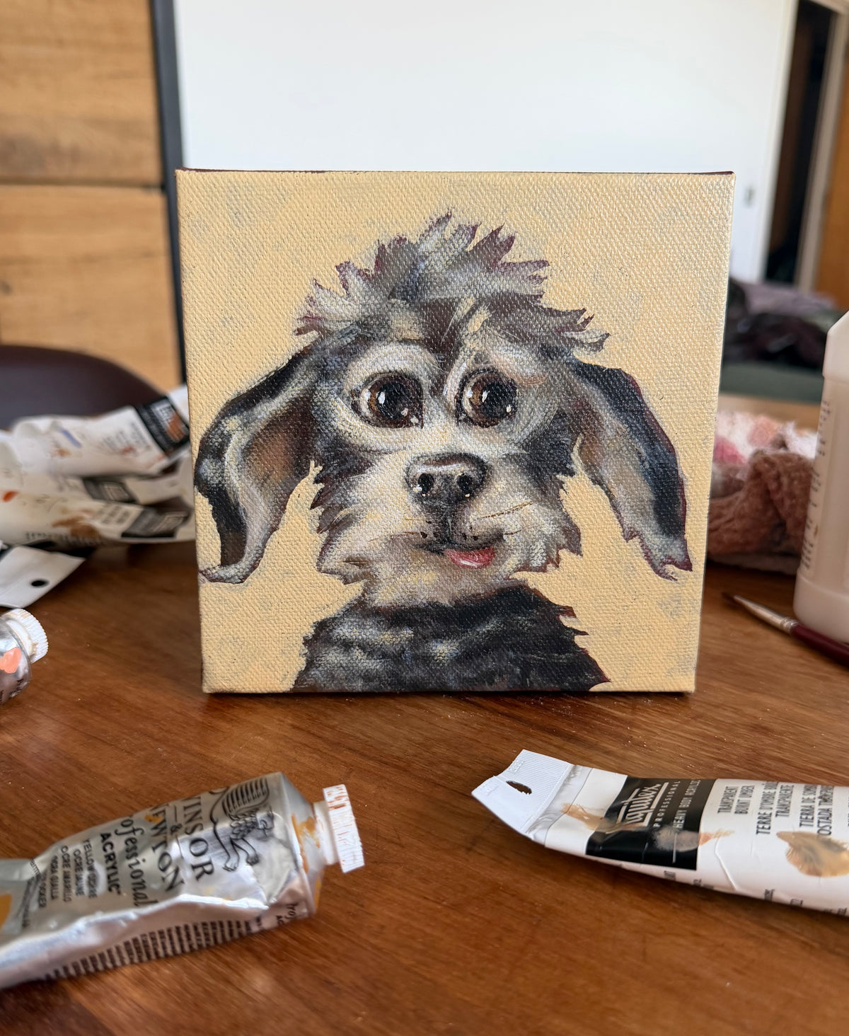 My Dear Old Friend expressive dog acrylic painting shown on an artist worktable with painting materials