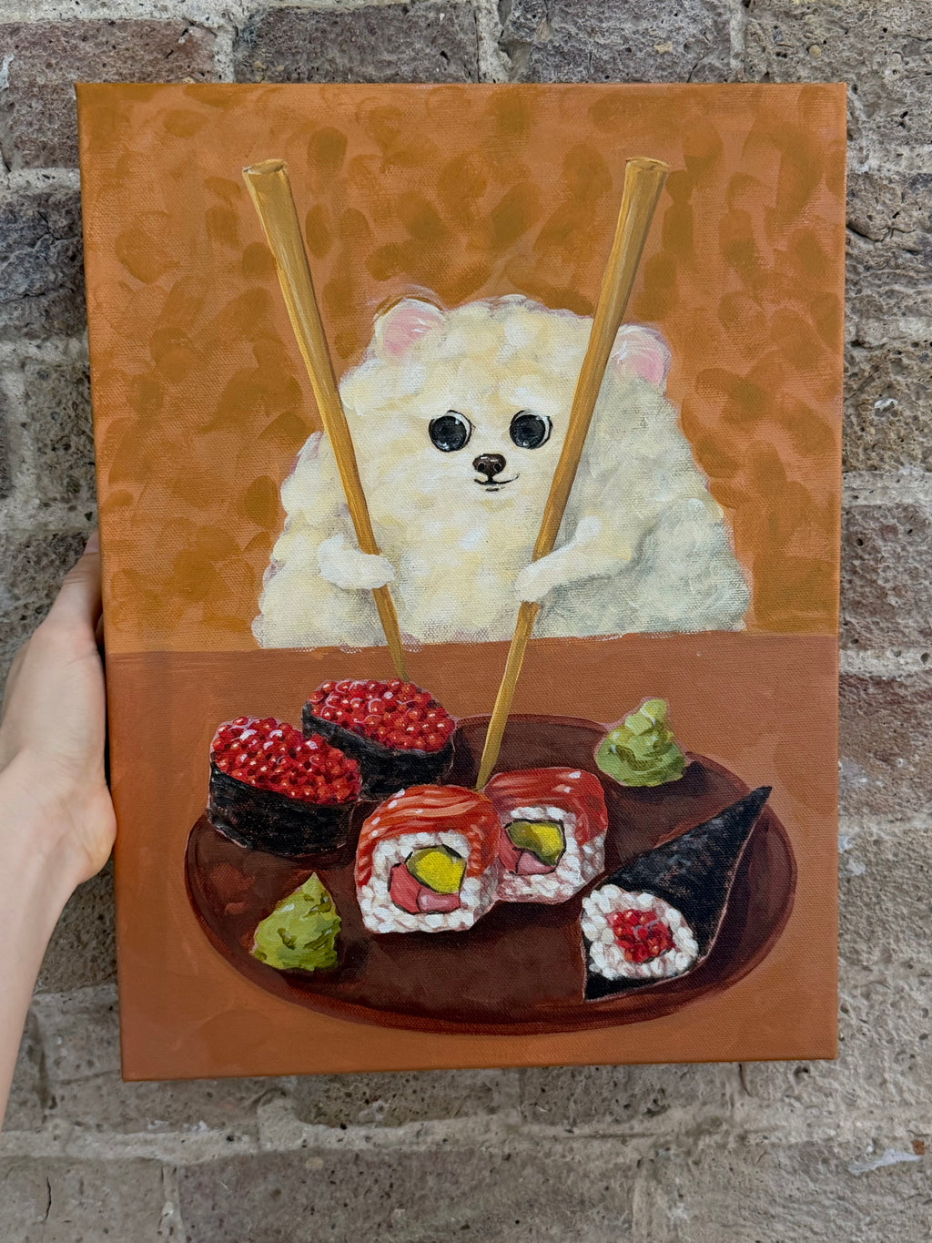 Sushi Lover dog and sushi acrylic painting displayed against a textured wall in a styled interior
